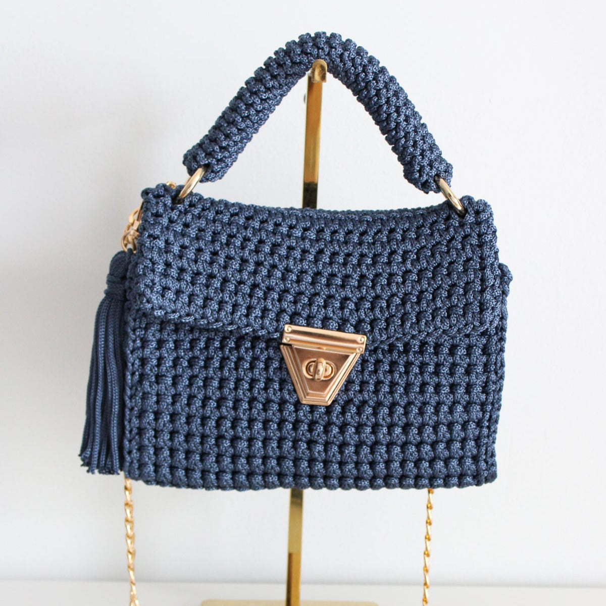 Crochet denim blue handbag. Handmade stylish purse with gold detailing and gold chain. Denim blue textured handbag with crossbody chain.