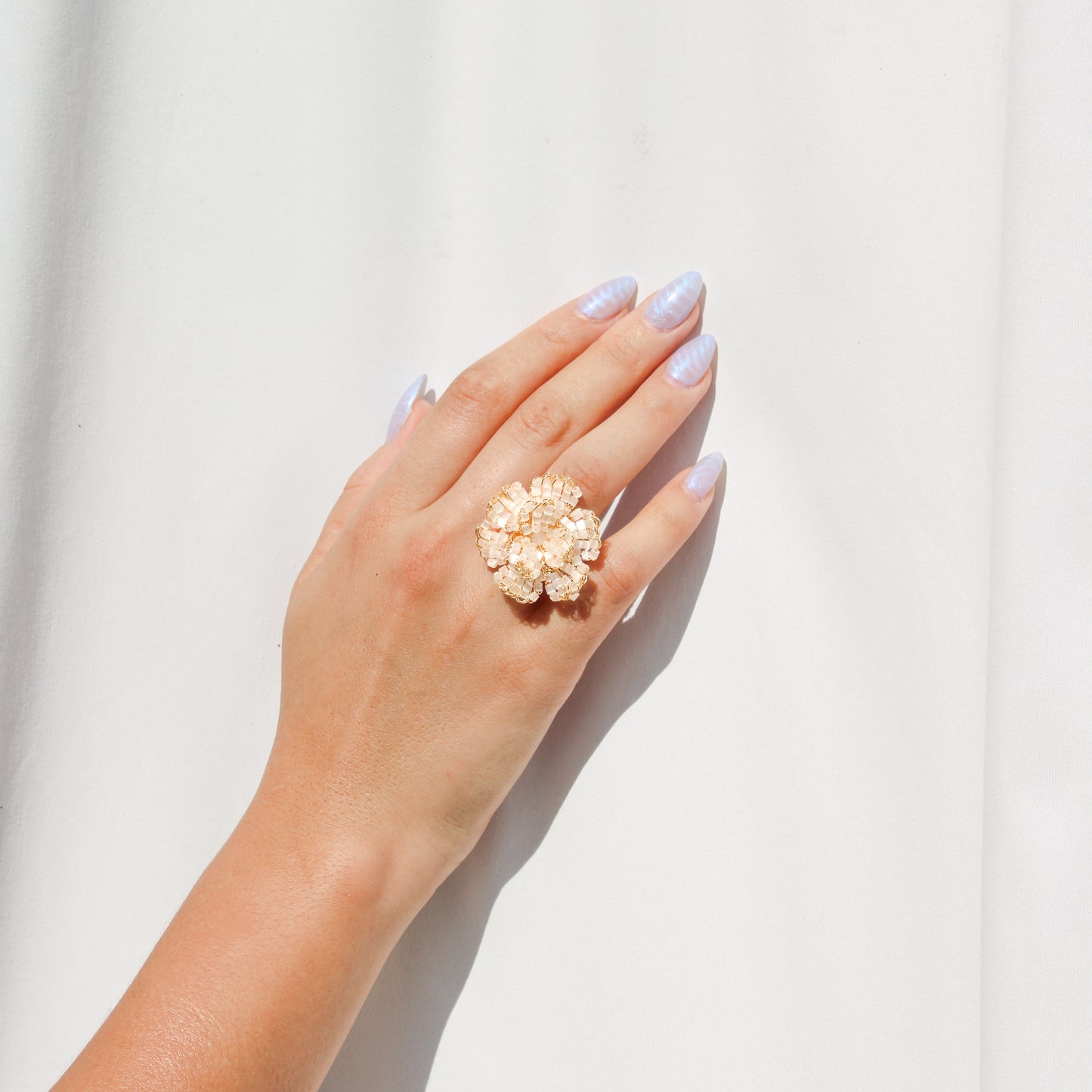 Handmade gold wire crochet flower ring with crystal beads, adjustable statement ring for women, artisan made beaded jewelry for weddings and gifts.