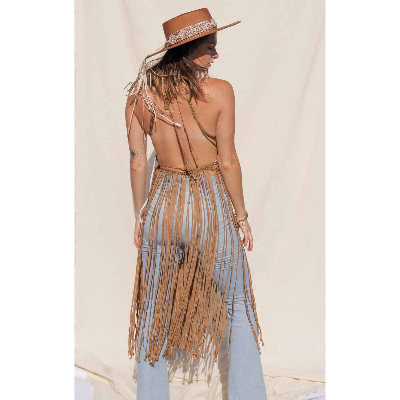 Luna caramel Macrame Dress (one size fits S - XL) Macrame beach cover up or fashion accessory. Halter Top and Wrap Dress closure. Colors available: Beige, Gold, Caramel, Brown. Care instructions: Steam to straighten any wrinkles. Dry clean or gentle hand wash. 100% rayon. Ethically made by Bolivian artisans.