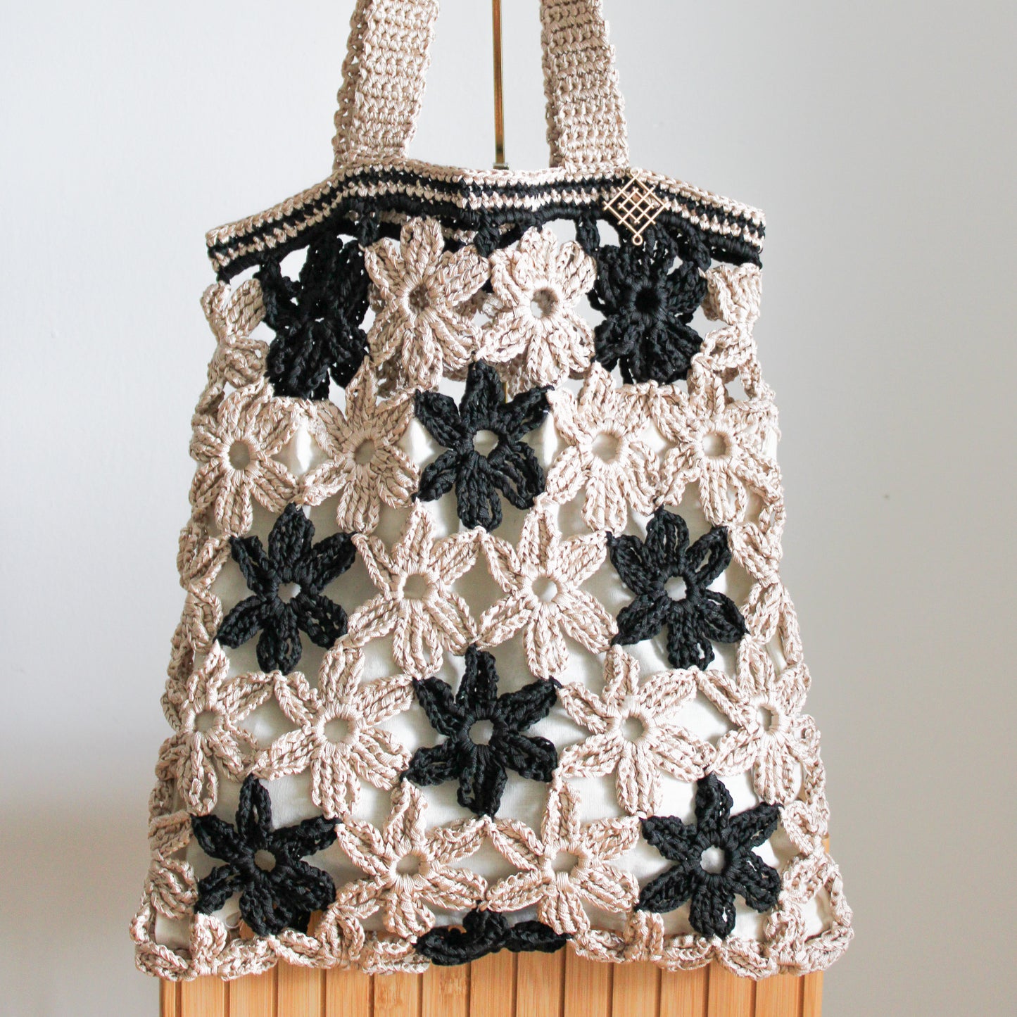 Handmade crochet flower tote bag in beige. This handmade tote bag features soft interior lining and pocket. each bag has over 40 crochet flowers and has lots of space to fit your stuff, like phone, wallet, glasses, make up bag, hat, etc. Perfect classy handmade tote bag in beige and black