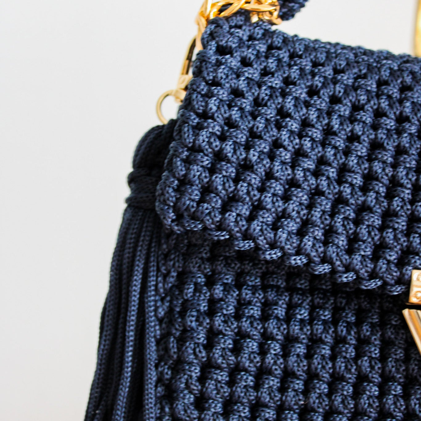 Handmade crochet navy blue woven purse. Handbag with crochet texture and gold details. Gold chain for crossbody or shoulder bag style. Made by hand