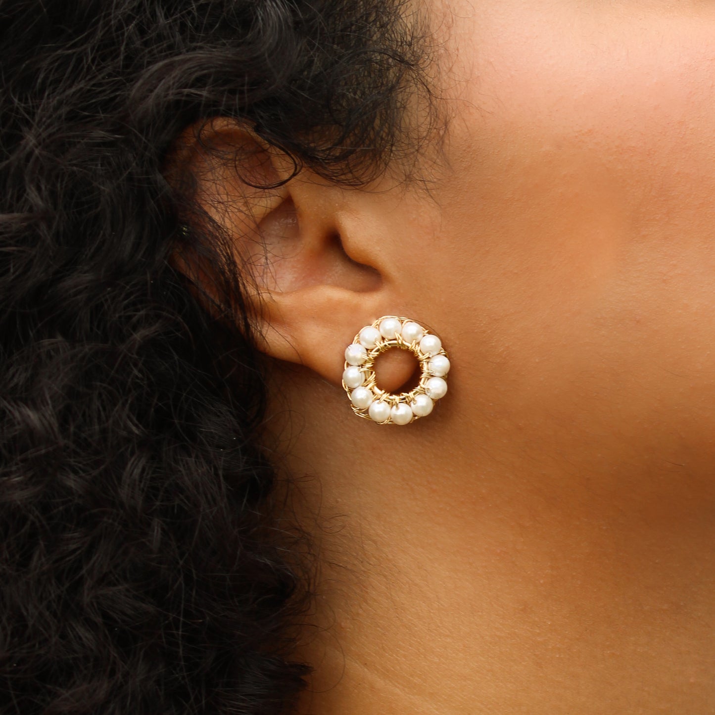 Double-ring earring design, handcrafted with pearls woven onto a gold-plated frame. A delicate chain connects the two cuffs on one side.  Lightweight geometric earrings