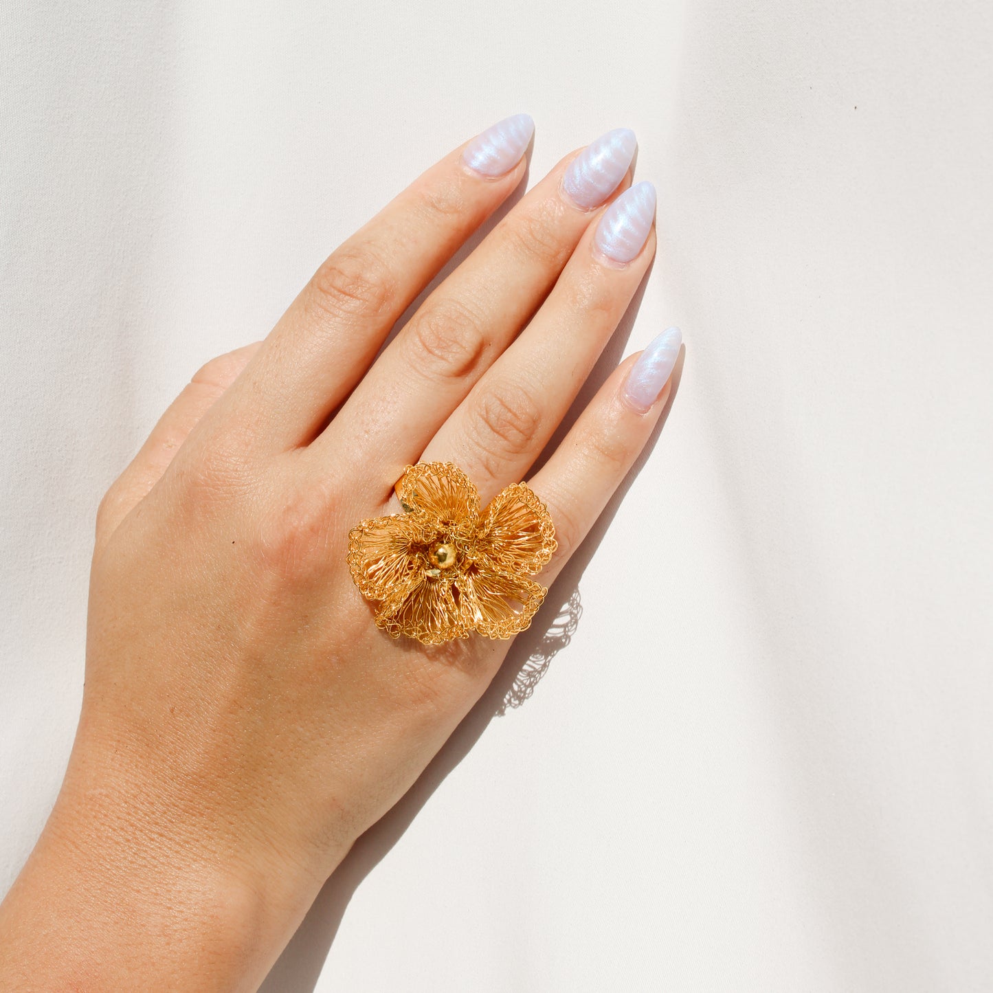 Handmade statement gold crochet ring. Flower inspired ring with gold bead center. Each petal is carefully woven with gold wire.