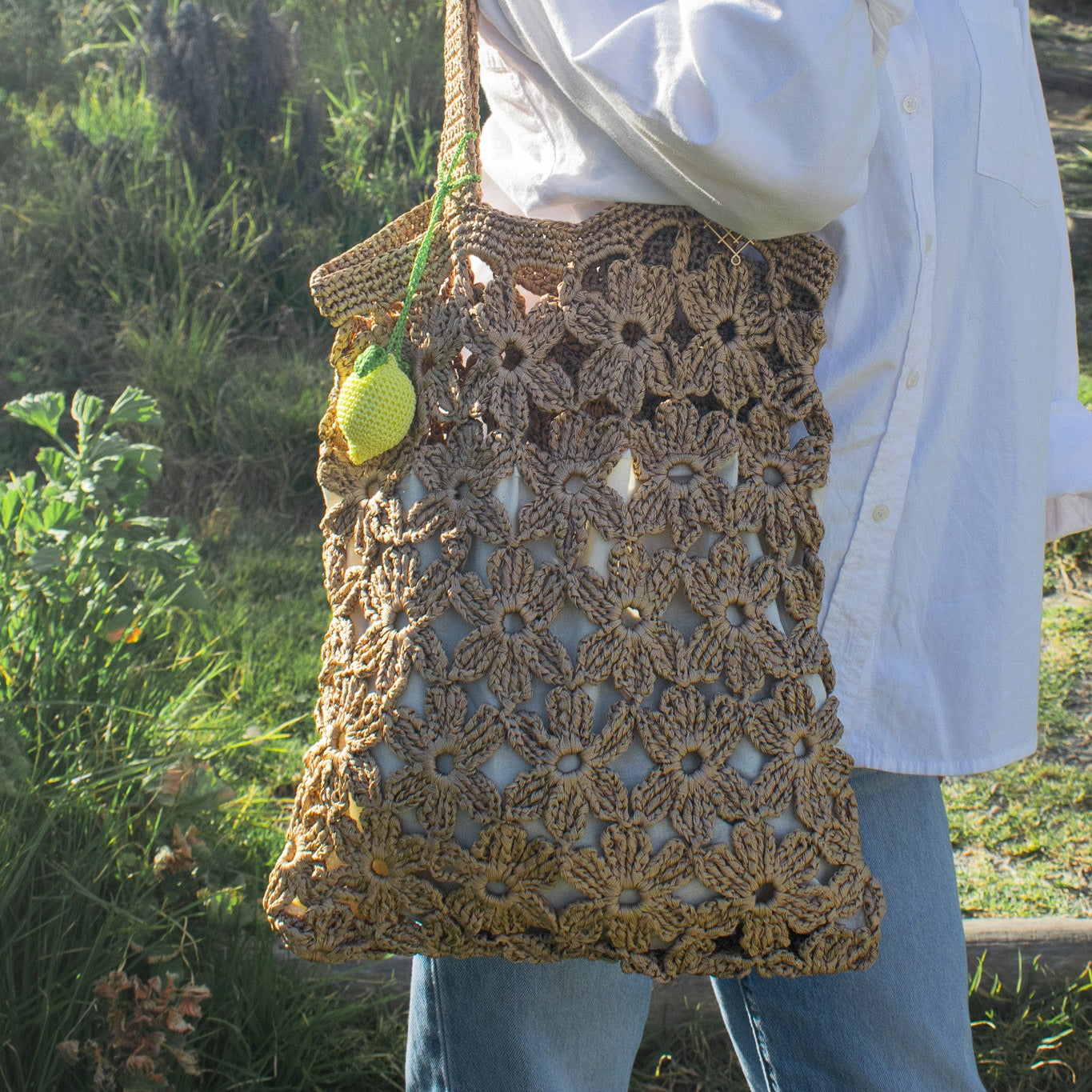 Handmade crochet flower tote bag in beige. This handmade tote bag features soft interior lining and pocket. each bag has over 40 crochet flowers and has lots of space to fit your stuff, like phone, wallet, glasses, make up bag, hat, etc. Perfect classy handmade tote bag in gold