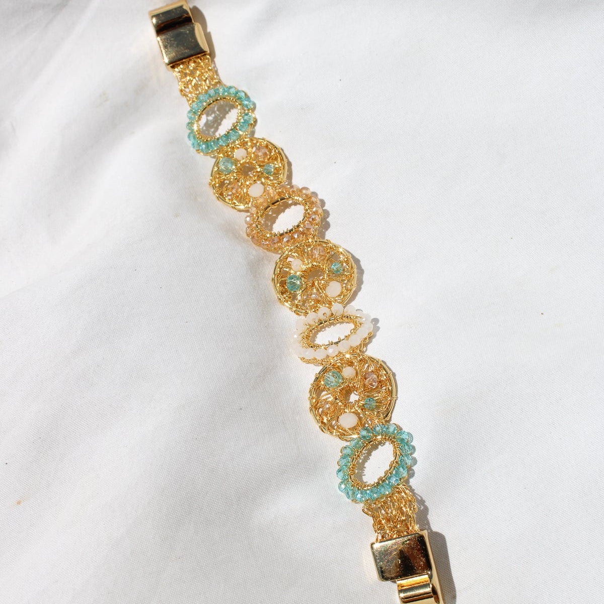 This unique handmade gold bracelet is the perfect way to add a pop of shimmer to your outfits. With pearls, crystal beads and gold wire. Multilayered handmade beautiful bracelet for woman.