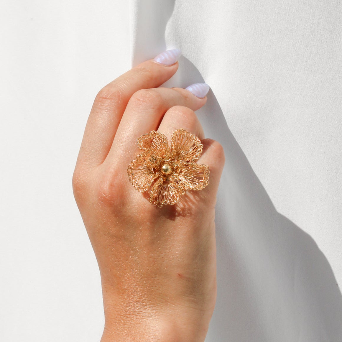 Handmade statement gold crochet ring. Flower inspired ring with gold bead center. Each petal is carefully woven with gold wire.