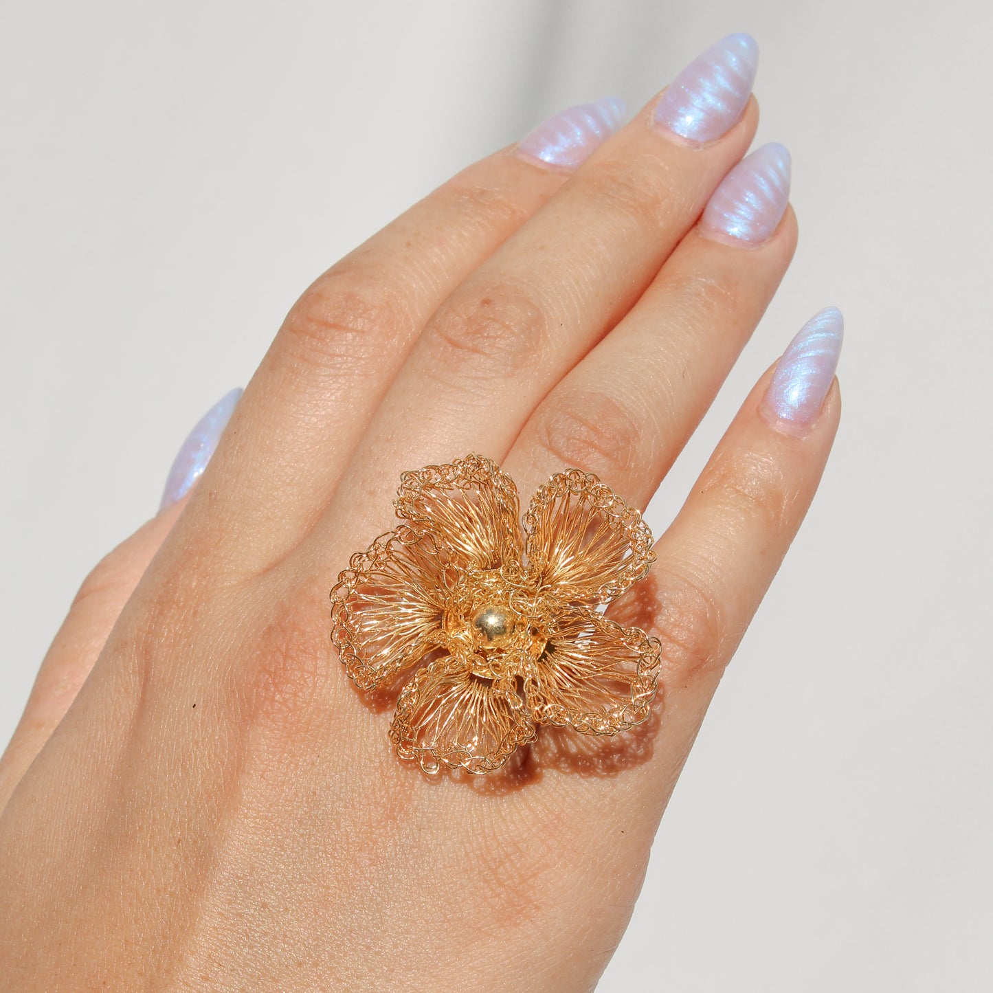 Handmade statement gold crochet ring. Flower inspired ring with gold bead center. Each petal is carefully woven with gold wire.
