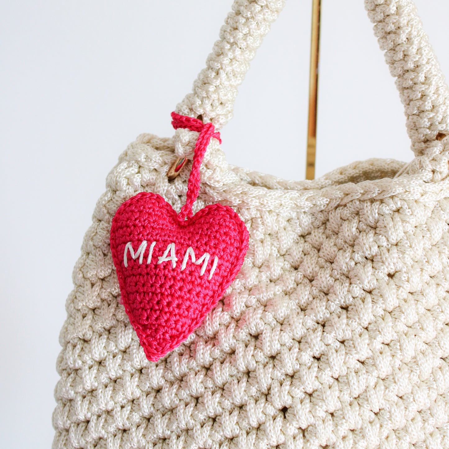 Crochet handmade miami heart charm bag. Make your bag look stylish and cute. Hot pink handmade charm for bags. Bright and cheerful accessory for bags or backpacks.  Crocheted by hand with soft, durable yarn and finished with embroidery. Perfect travel souvenir MIAMI Handmade amigurumi crochet heart.