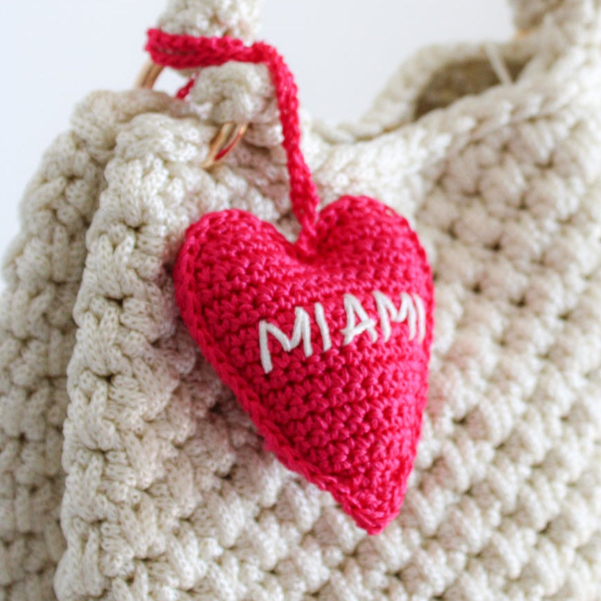 Crochet handmade miami heart charm bag. Make your bag look stylish and cute. Hot pink handmade charm for bags. Bright and cheerful accessory for bags or backpacks.  Crocheted by hand with soft, durable yarn and finished with embroidery. Perfect travel souvenir MIAMI Handmade amigurumi crochet heart.