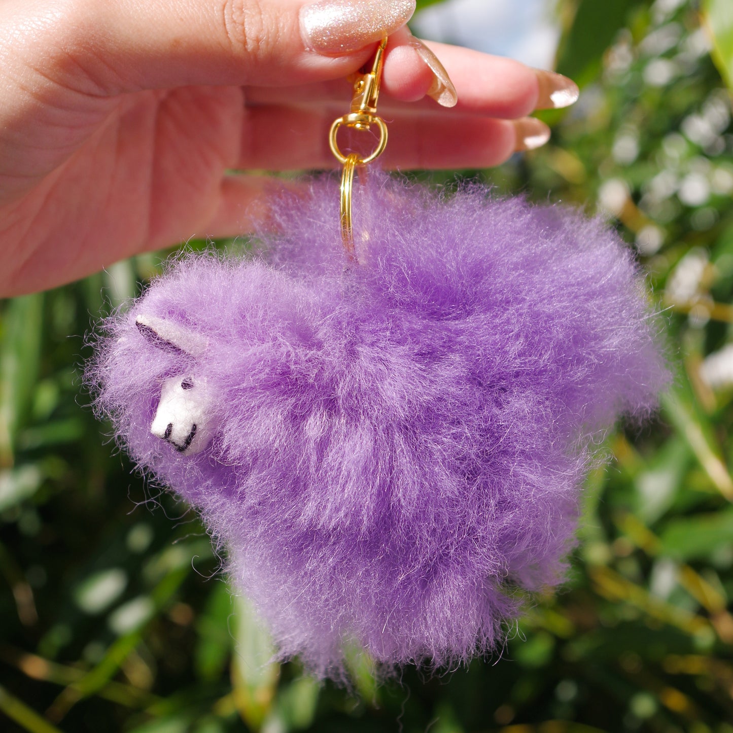 Purple Llama plushie pom pom keychain. Pom Pom size 3” in approx. Made with 100% alpaca wool. Made by Bolivian and Peruvian artisans. Colors Available: pink, white, beige, purple. Adult or children gift