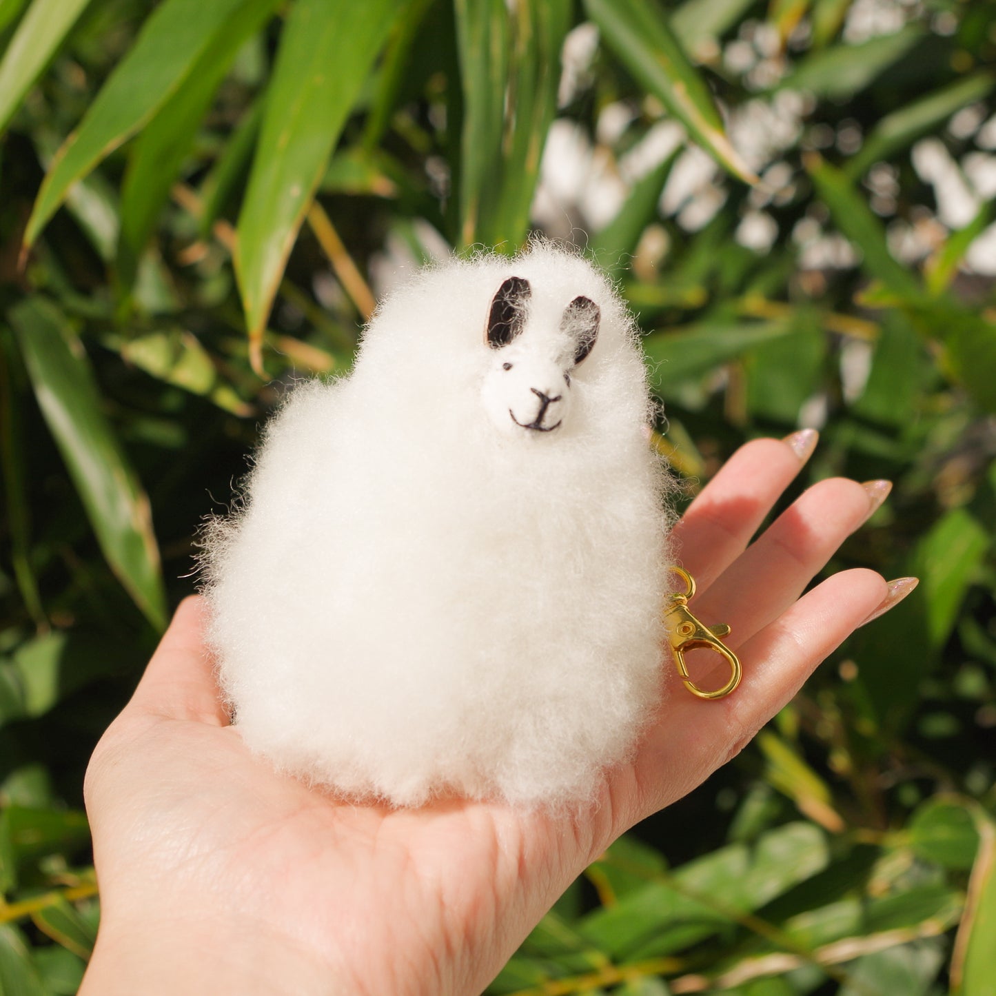 White Llama plushie pom pom keychain. Pom Pom size 3” in approx. Made with 100% alpaca wool. Made by Bolivian and Peruvian artisans. Colors Available: pink, white, beige, purple. Adult or children gift