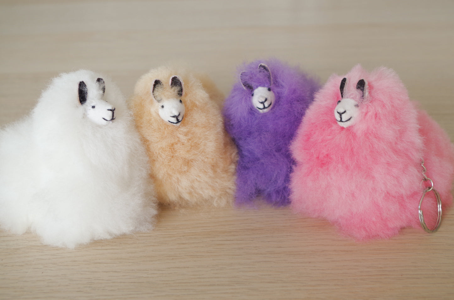 Llama plushie pom pom keychain. Pom Pom size 3” in approx. Made with 100% alpaca wool. Made by Bolivian and Peruvian artisans. Colors Available: pink, white, beige, purple. Adult or children gift