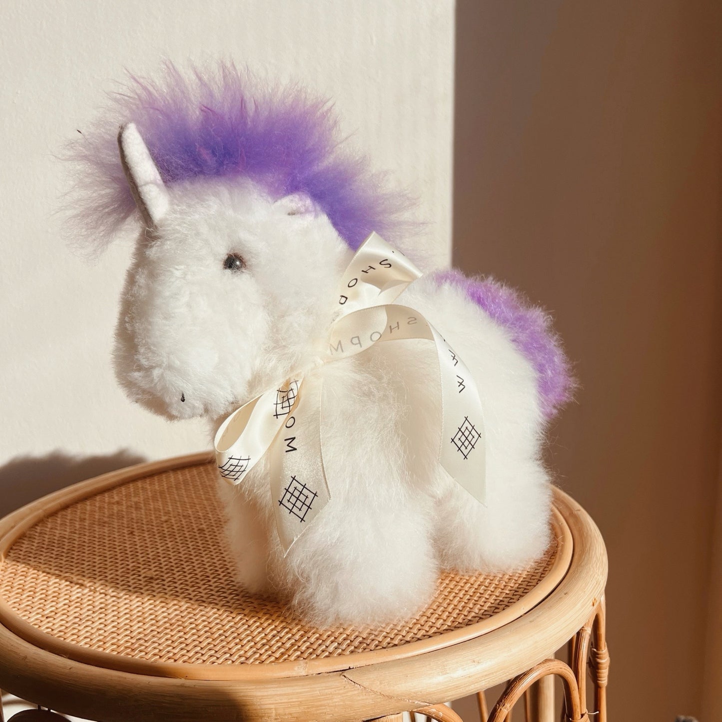 Alpaca wool unicorn plushie gift or home decoration. 100% baby  
alpaca wool. Handmade by Bolivian and Peruvian artisans. Purple stuffed unicorn