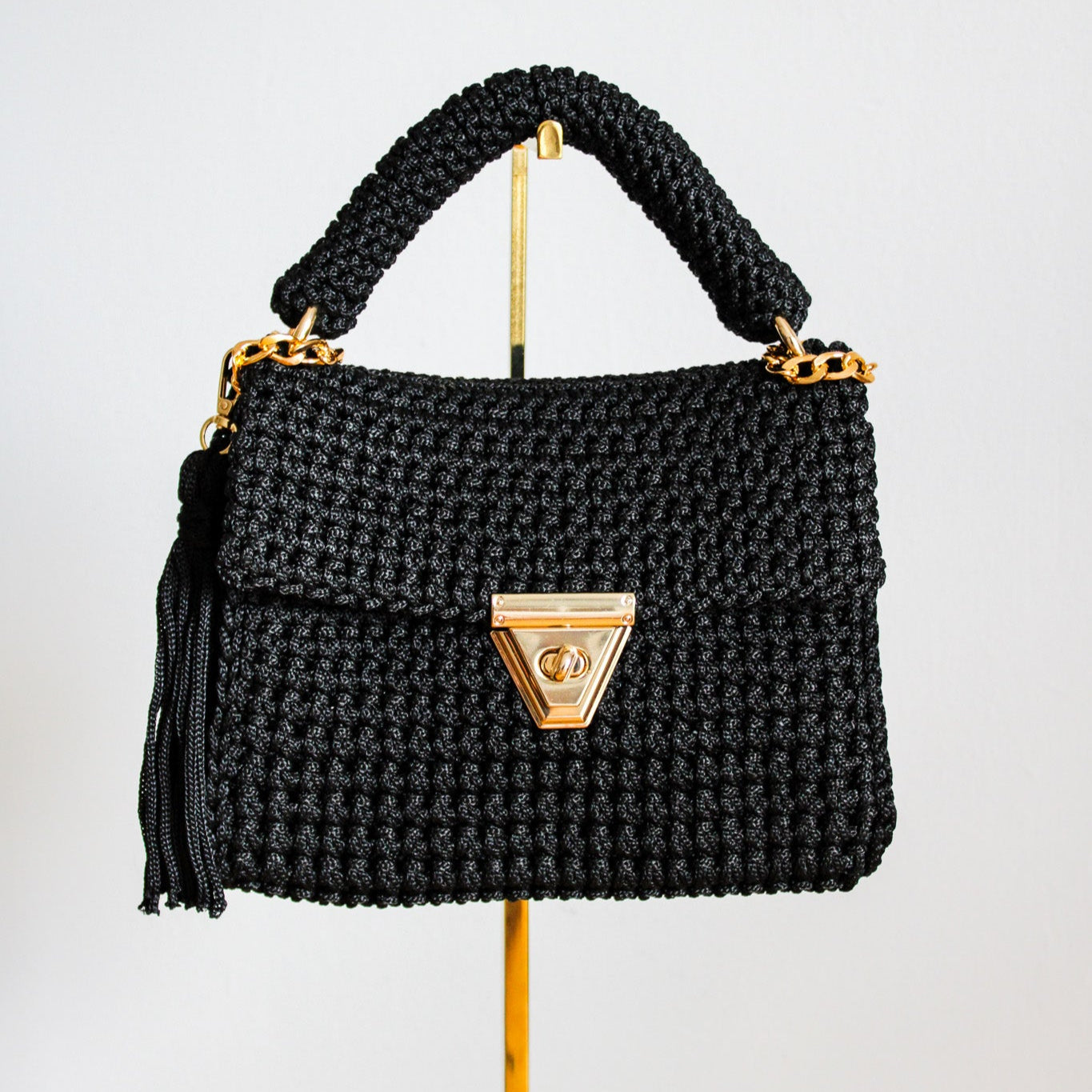 Handmade crochet black woven purse. Handbag with crochet texture and gold details. Gold chain for crossbody or shoulder bag style. Made by hand