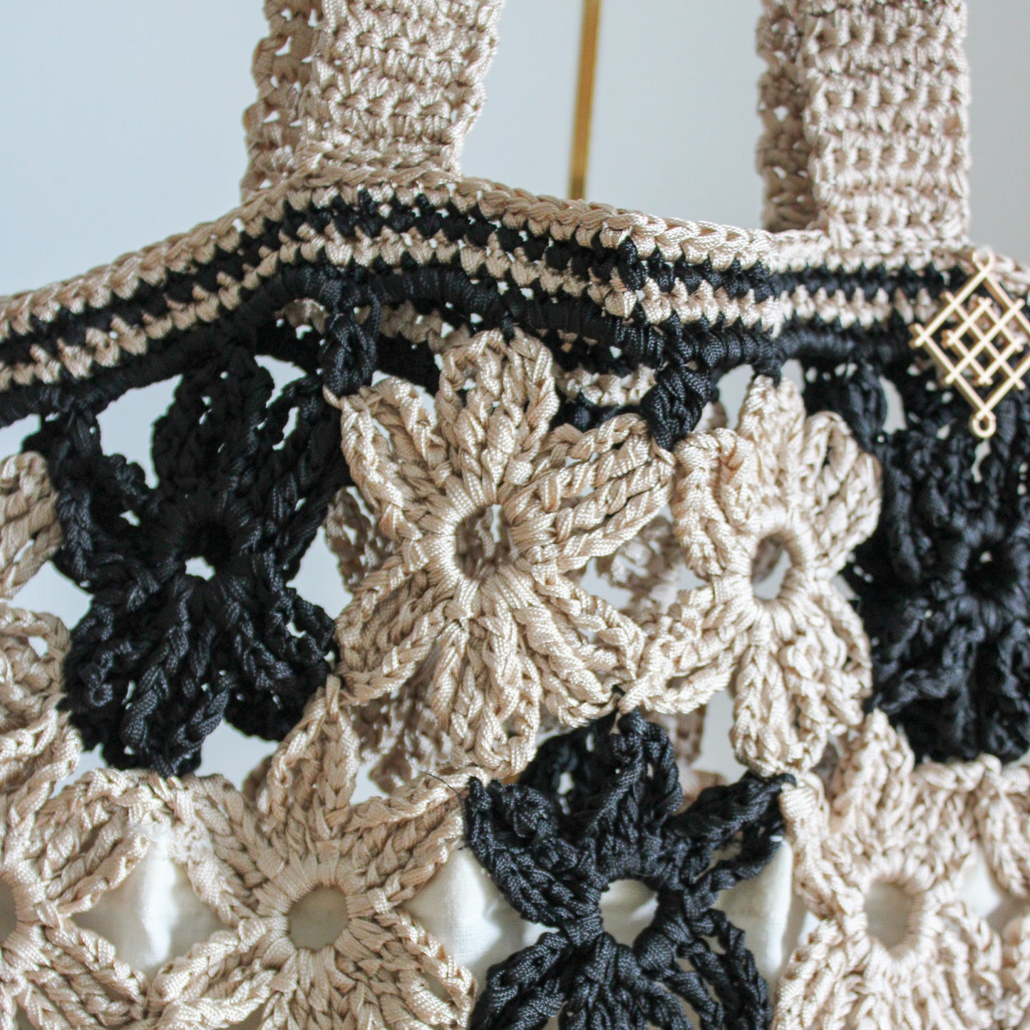 Handmade crochet flower tote bag in beige. This handmade tote bag features soft interior lining and pocket. each bag has over 40 crochet flowers and has lots of space to fit your stuff, like phone, wallet, glasses, make up bag, hat, etc. Perfect classy handmade tote bag in beige and black