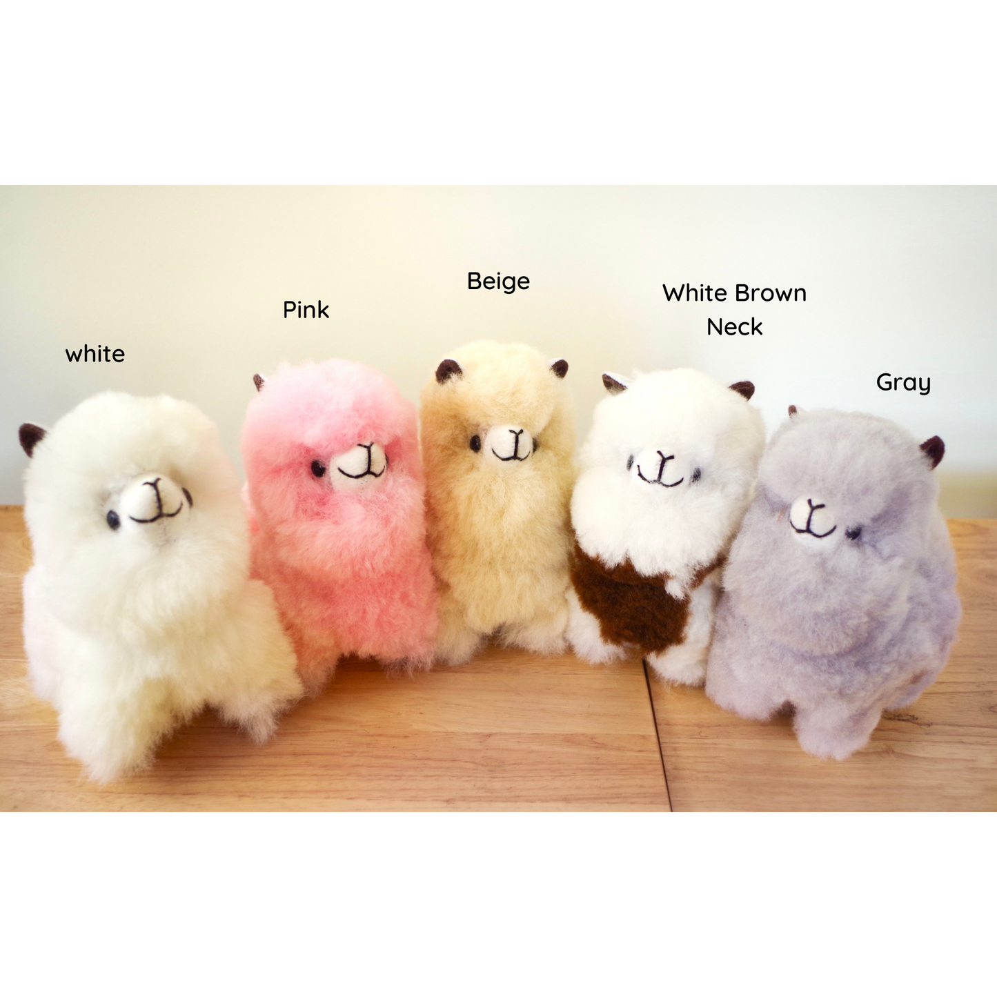 Home decor or gift soft llama plushies. 100% alpaca wool plushies. Made by Bolivian and Peruvian artisans. Colors available: Pink, Beige, White, Gray. Sizes: 8 x 8 in