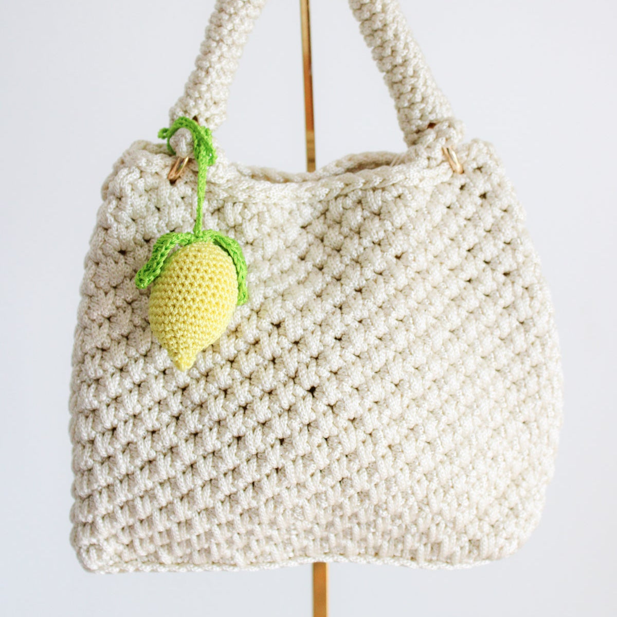 Bright and cheerful lemon accessory for bags or backpacks.  Crocheted by hand with soft, durable yarn and finished with a green crochet leaf detail. Handmade amigurumi crochet fruits.