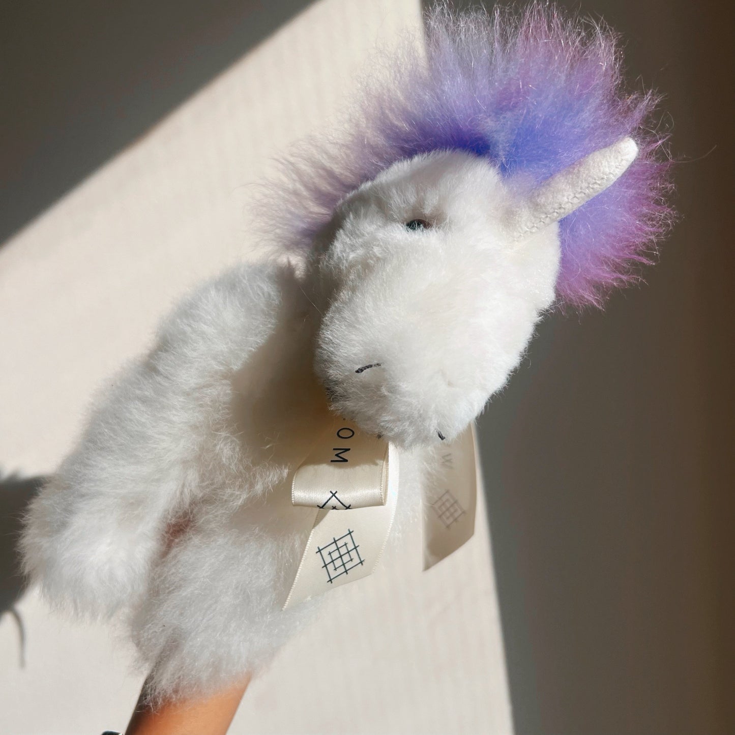 Alpaca wool unicorn plushie gift or home decoration. 100% baby  
alpaca wool. Handmade by Bolivian and Peruvian artisans. Lilac & white stuffed unicorn