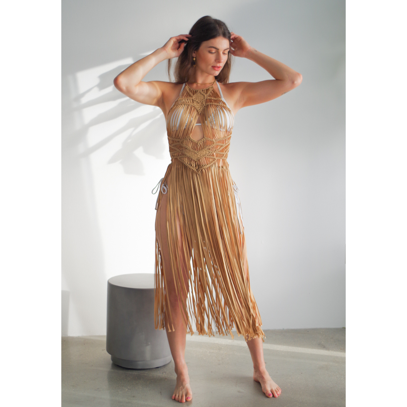 Luna caramel Macrame Dress (one size fits S - XL) Macrame beach cover up or fashion accessory. Halter Top and Wrap Dress closure. with fringe skirt Colors available: Beige, Gold, Caramel, Brown. Care instructions: Steam to straighten any wrinkles. Dry clean or gentle hand wash. 100% rayon. Ethically made by Bolivian artisans.