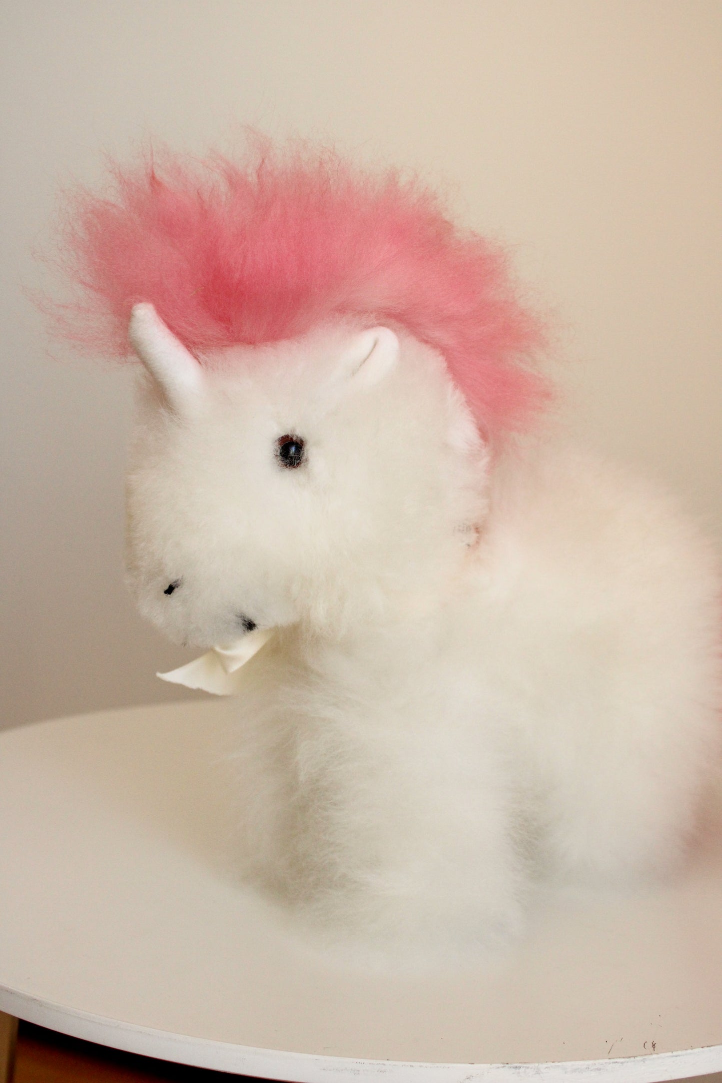 Alpaca wool unicorn plushie gift or home decoration. 100% baby  
alpaca wool. Handmade by Bolivian and Peruvian artisans. Pink stuffed unicorn