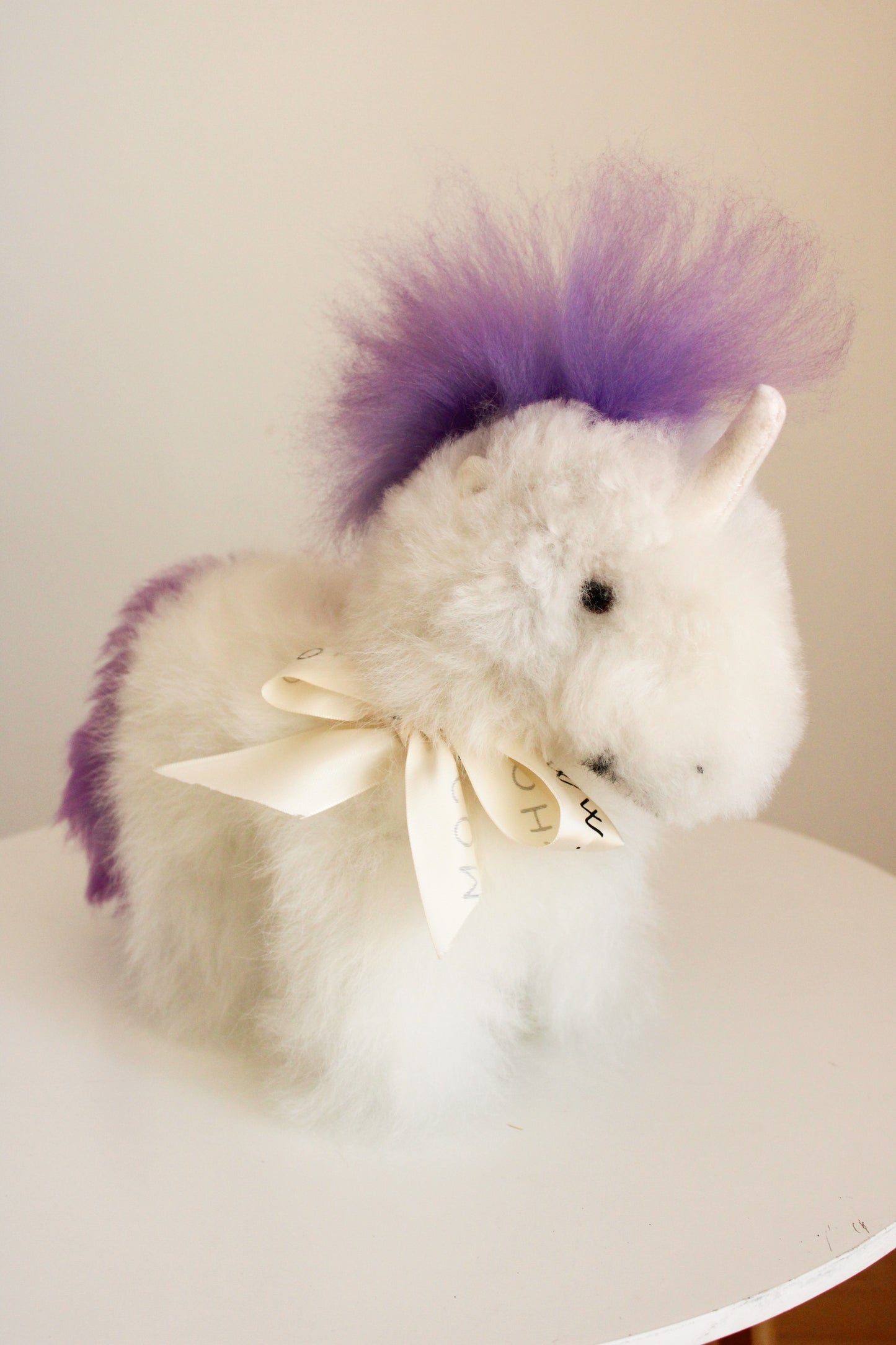 Alpaca wool unicorn plushie gift or home decoration. 100% baby  
alpaca wool. Handmade by Bolivian and Peruvian artisans. Purple lilac stuffed unicorn