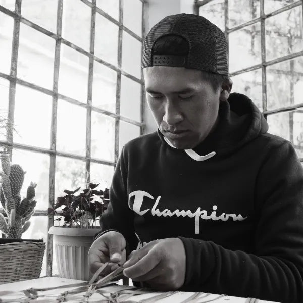 Artisan weaving a fashion accessory