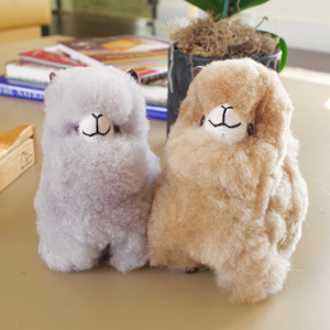 Home decor or gift soft llama plushies. 100% alpaca wool plushies. Made by Bolivian and Peruvian artisans. Colors available: Pink, Beige, White, Gray. Sizes: 8 x 8 in"