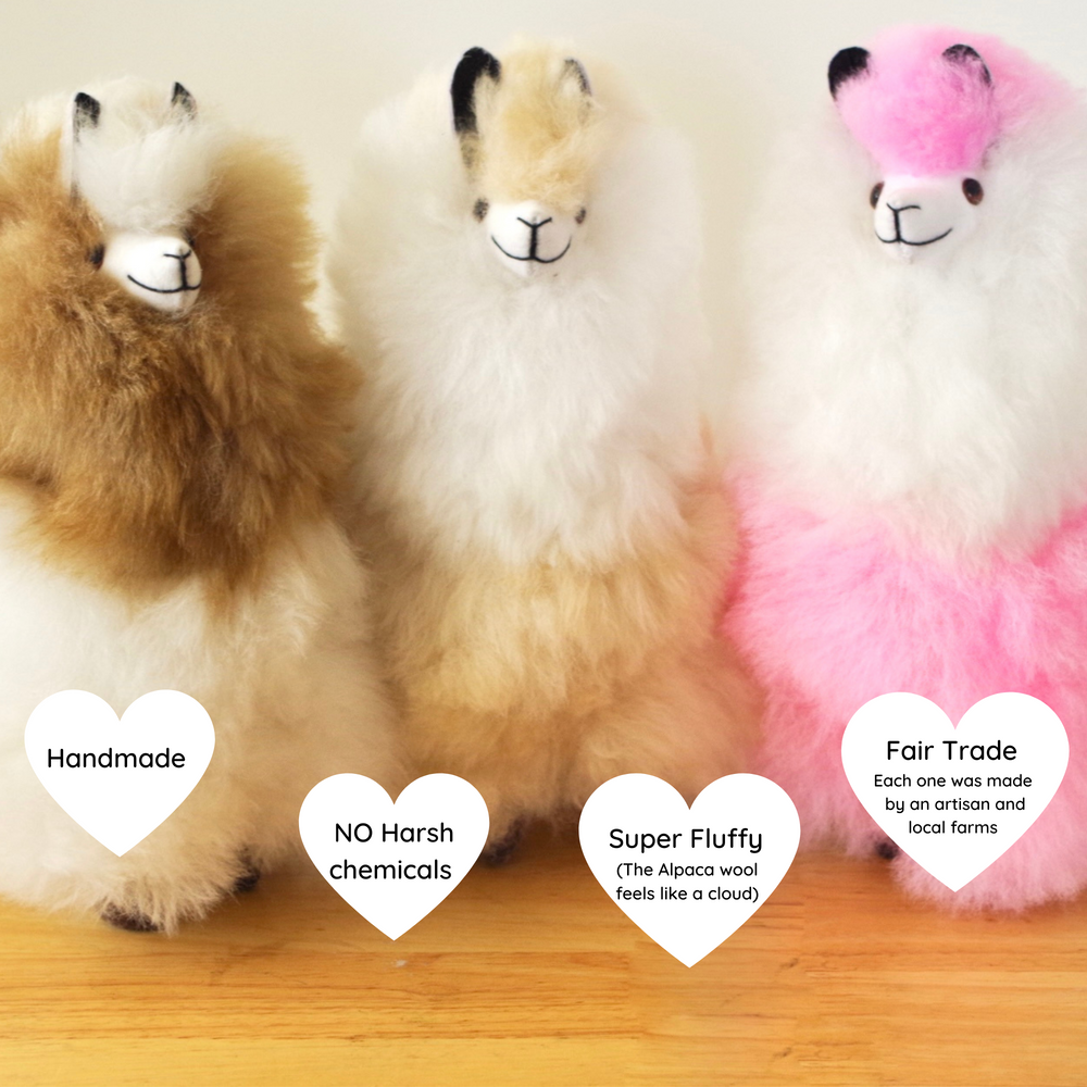 Llama plushie for home decor or gift. Medium size 12" in. Made with 100% alpaca wool. Made by Bolivian and Peruvian artisans. Colors Available: pink, white, beige, purple. Adult or children gift