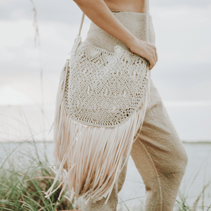 Macrame crossbody bag with fringes. Color: Beige . Includes lining and zipper. Handmade in Bolivia. Hand Wash and professional cleaning only. 100% Rayon