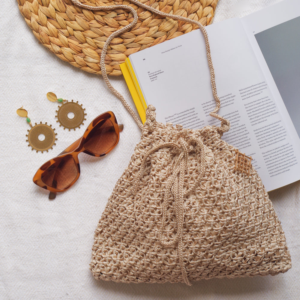 
                      
                        Handmade purse. Crochet strap, Fully lined, includes pockets. Drawstring macrame bag perfect for traveling. 
                      
                    