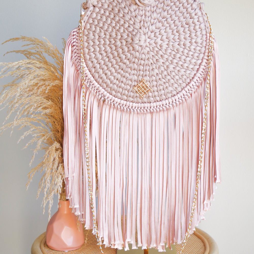 
                      
                        Blush Rounded crossbody bag with fringes and chain strap. Made with crochet and macrame techniques. Boho Style. Color: Blush. Includes lining and zipper. Handmade in Bolivia. Hand Wash and professional cleaning only. 100% Rayon
                      
                    