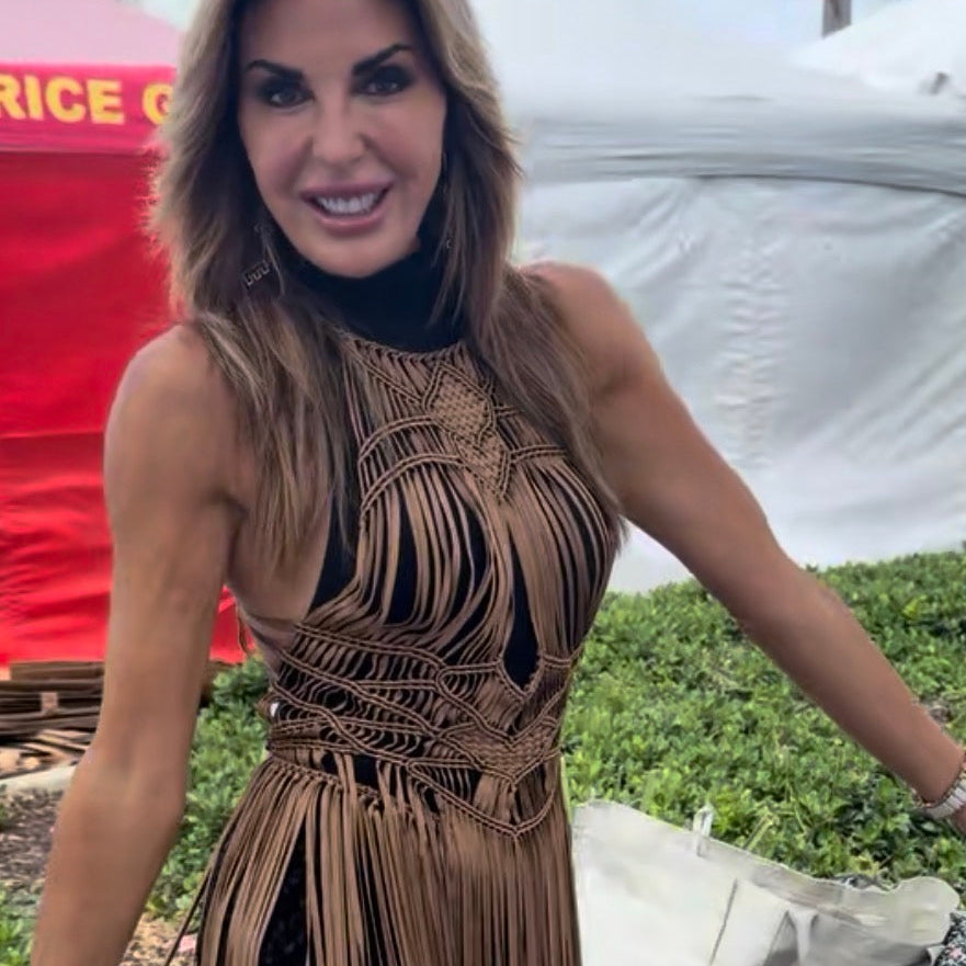 Woman wearing a brown Luna fringed dress outdoors with a blurred background