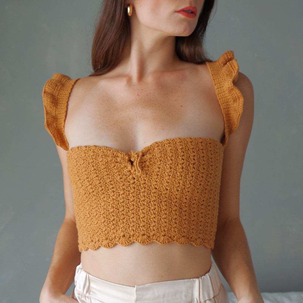 
                      
                        Handmade crochet corset top. 100% cotton with ruffled sleeves, square neckline.
                      
                    