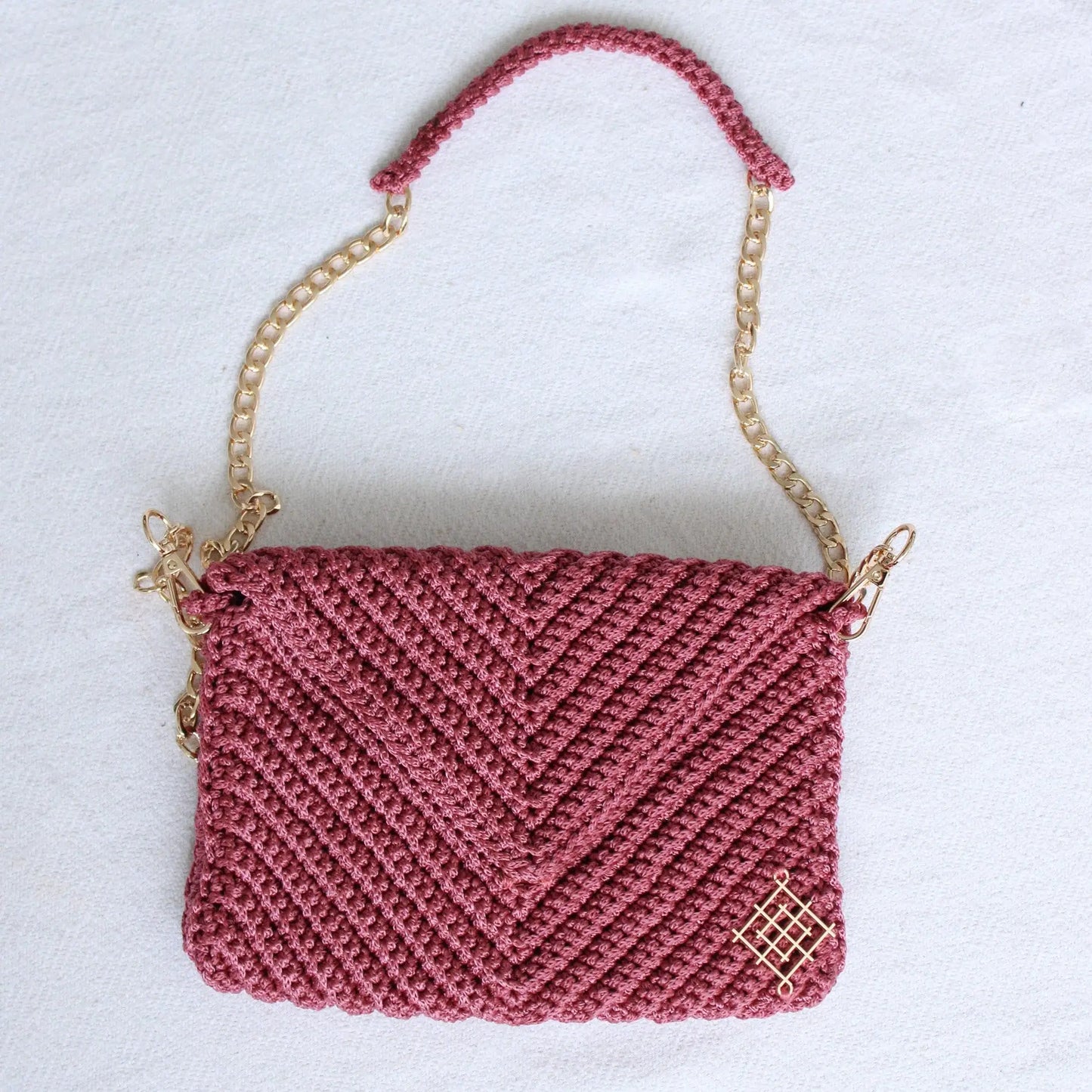 Handmade crochet envelope bags. Rectangular crochet cutches with detachable gold chain strap. Features inside pocket and magnetic closure. Handmade by skilled artisans