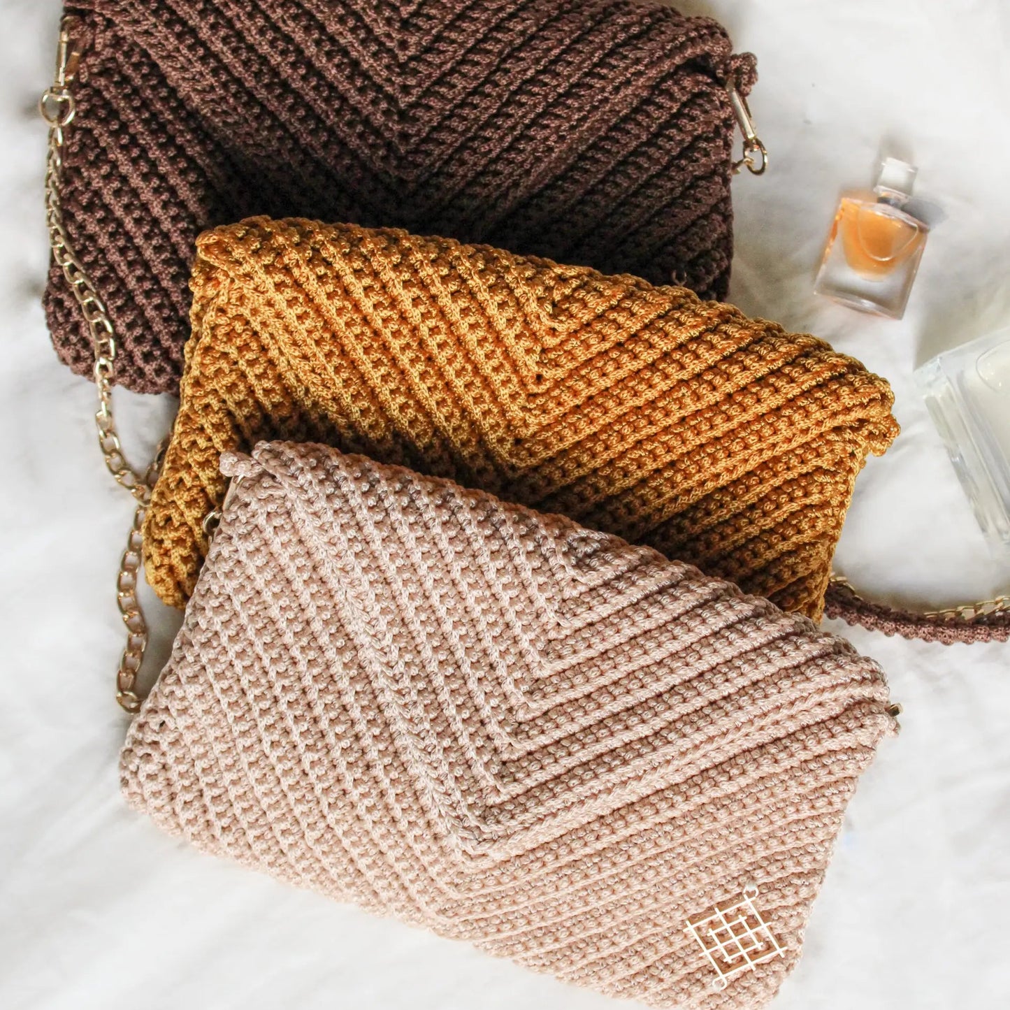 Handmade crochet envelope bags. Rectangular crochet cutches with detachable gold chain strap. Features inside pocket and magnetic closure. Handmade by skilled artisans