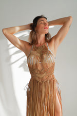 Luna_Macrame_Dress_Beach_Cover_Up_for_Women_chest_view_detail  2048 × 2048px  Luna Macrame Dress (one size fits S - XL) Macrame beach cover up or fashion accessory. Halter Top and Wrap Dress closure. Colors available: Beige, Gold, Caramel, Brown. Care instructions: Steam to straighten any wrinkles. Dry clean or gentle hand wash. 100% rayon. Ethically made by Bolivian artisans.