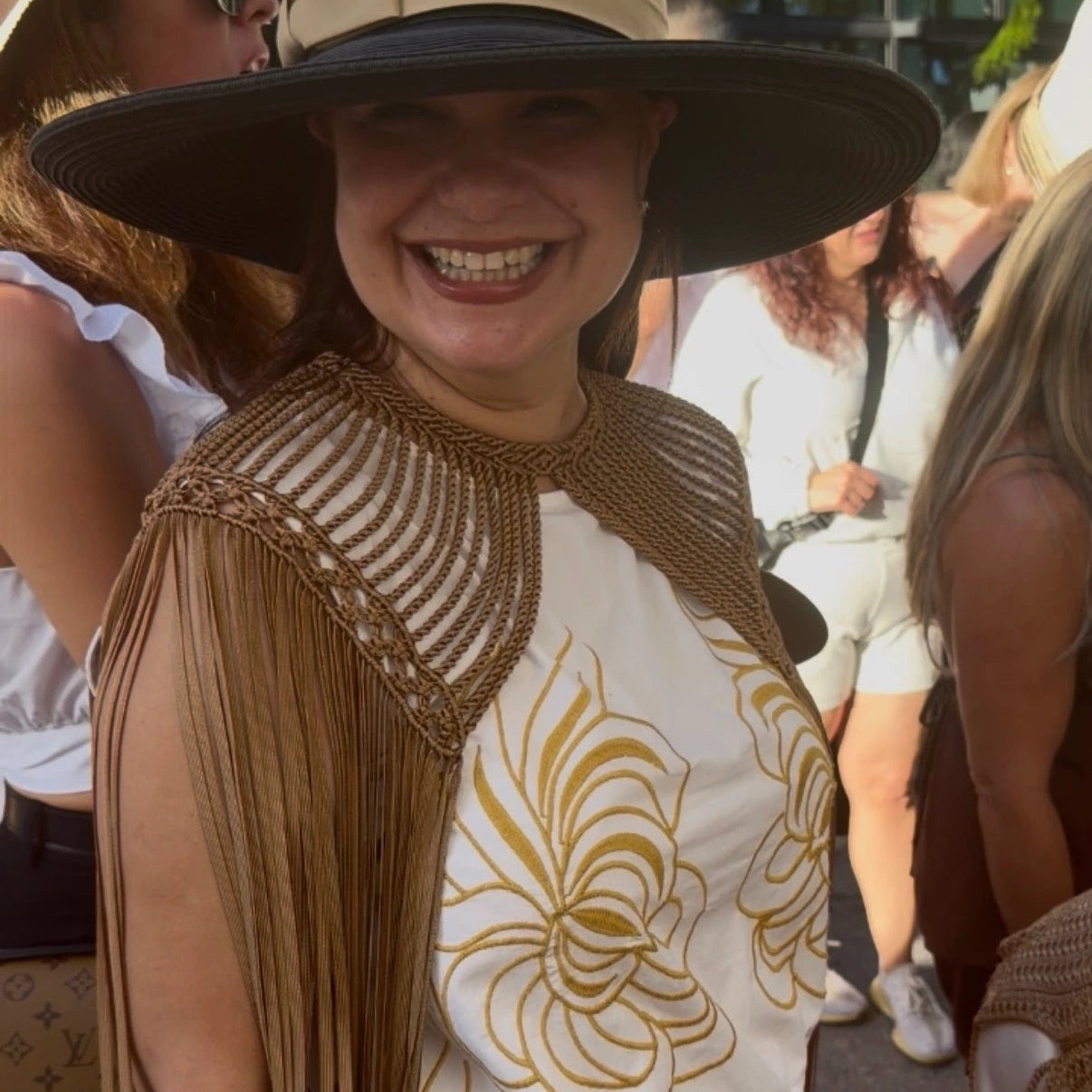 Woman smiling wearing leia cape bronze in a summer event