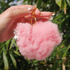 Pink side view Llama plushie pom pom keychain. Pom Pom size 3” in approx. Made with 100% alpaca wool. Made by Bolivian and Peruvian artisans. Colors Available: pink, white, beige, purple. Adult or children gift 
