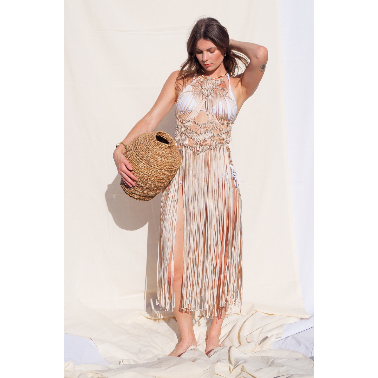 Luna beige Macrame Dress (one size fits S - XL) Macrame beach cover up or fashion accessory. Halter Top and Wrap Dress closure. with fringe skirt Colors available: Beige, Gold, Caramel, Brown. Care instructions: Steam to straighten any wrinkles. Dry clean or gentle hand wash. 100% rayon. Ethically made by Bolivian artisans.