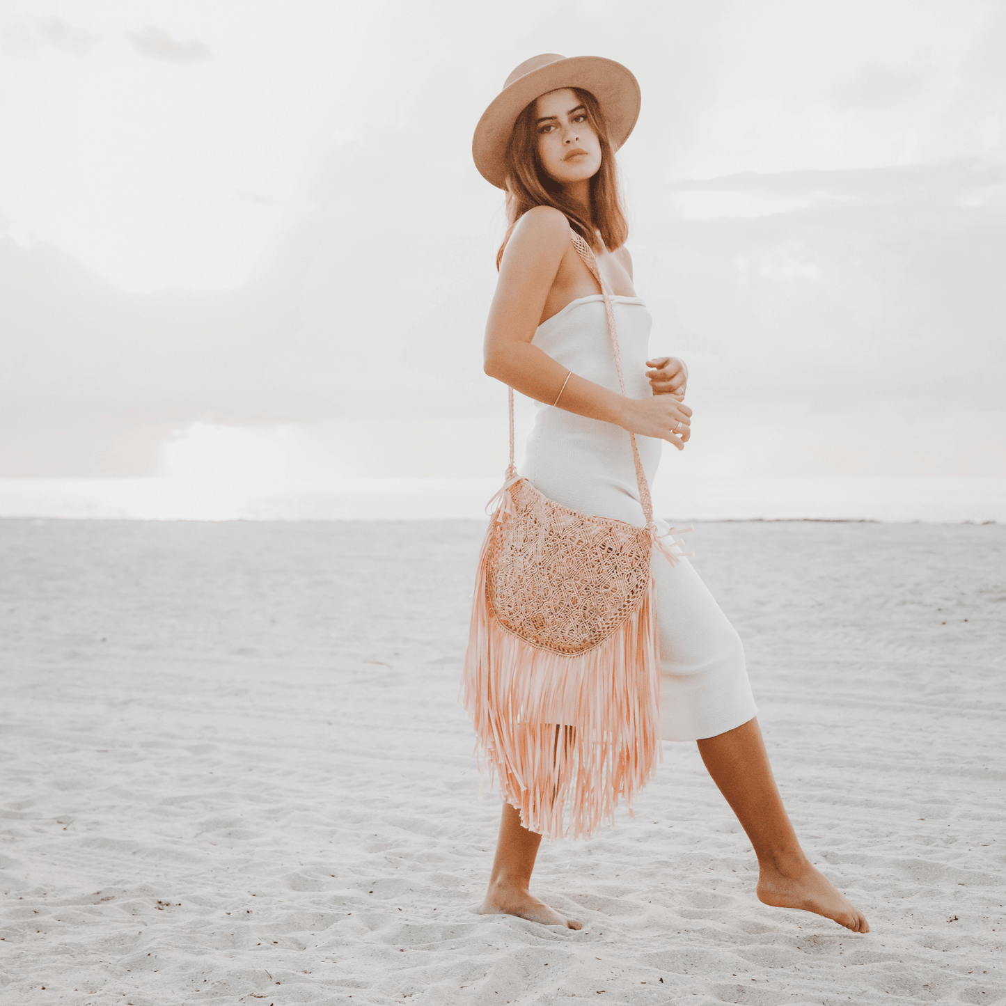 Macrame crossbody bag with fringes. Color: Coral. Includes lining and zipper. Handmade in Bolivia. Hand Wash and professional cleaning only. 100% Rayon