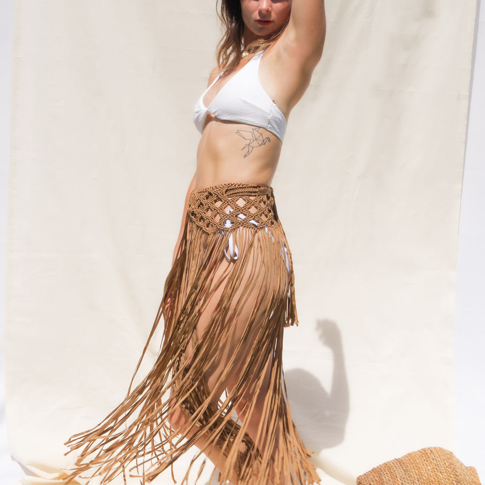 
                      
                        Caramel Marina Macrame Beach Skirt, top or Belt Boho Beach Cover Up with tassels. Weaving width: 6" in Fringe length: 26" in approx. Tie Closure. Handmade in Bolivia. Handwash only. One size fits all 
                      
                    