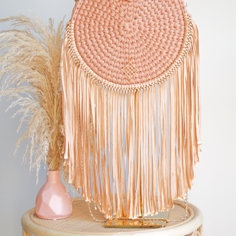 
                      
                        Terracotta Rounded crossbody bag with fringes and chain strap. Made with crochet and macrame techniques. Boho Style. Color: burnt orange. Includes lining and zipper. Handmade in Bolivia. Hand Wash and professional cleaning only. 100% Rayon
                      
                    