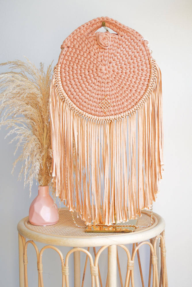 Terracotta Rounded crossbody bag with fringes and chain strap. Made with crochet and macrame techniques. Boho Style. Color: burnt orange. Includes lining and zipper. Handmade in Bolivia. Hand Wash and professional cleaning only. 100% Rayon