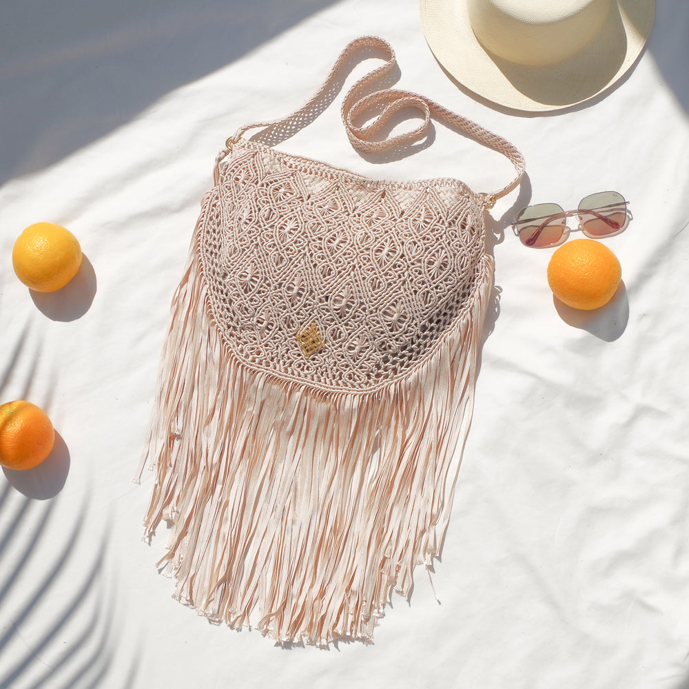 
                      
                        Beige Macrame crossbody bag with fringes. Includes lining and zipper. Handmade in Bolivia. Hand Wash and professional cleaning only. 100% Rayon
                      
                    