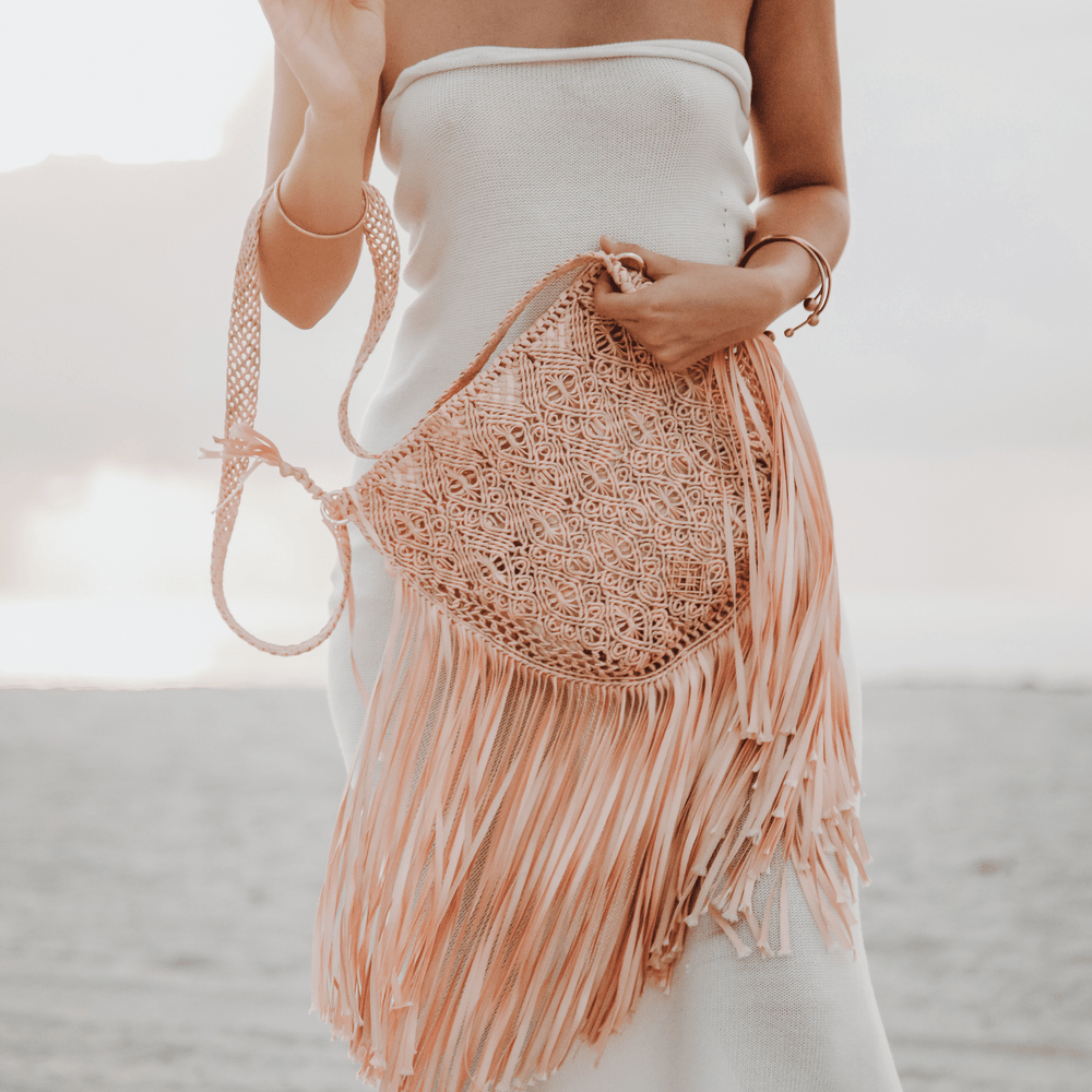 Macrame crossbody bag with fringes. Color: Coral. Includes lining and zipper. Handmade in Bolivia. Hand Wash and professional cleaning only. 100% Rayon
