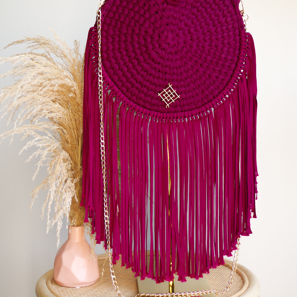 
                      
                        Wine Rounded crossbody bag with fringes and chain strap. Made with crochet and macrame techniques. Boho Style. Color: Wine. Includes lining and zipper. Handmade in Bolivia. Hand Wash and professional cleaning only. 100% Rayon
                      
                    