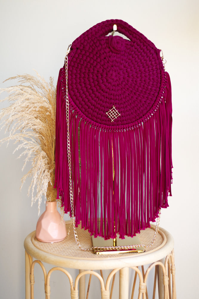 Wine Rounded crossbody bag with fringes and chain strap. Made with crochet and macrame techniques. Boho Style. Color: Wine. Includes lining and zipper. Handmade in Bolivia. Hand Wash and professional cleaning only. 100% Rayon
