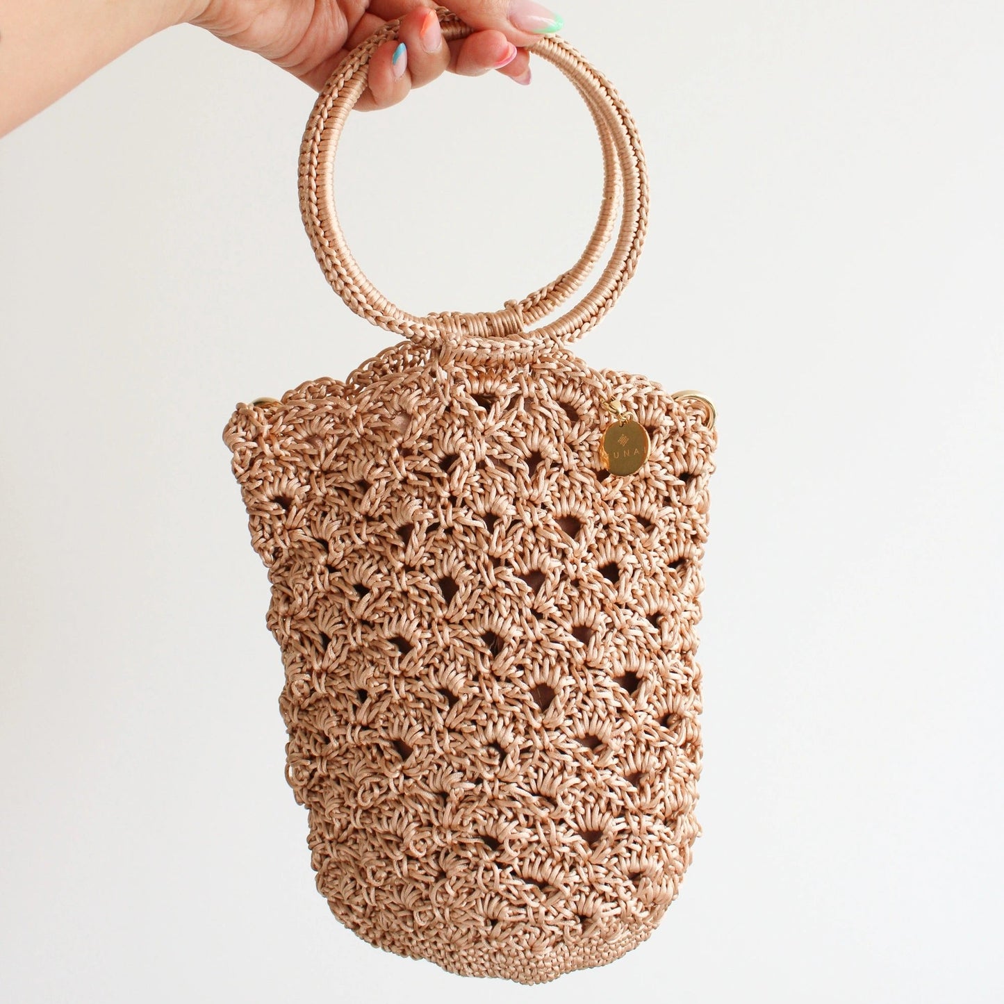 Handmade crochet handbag with a rigid circular top handle and gold chain strap. Featuring an intricate, open-work crochet pattern and circular top handles. 