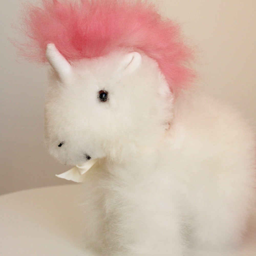 
                      
                        Alpaca wool unicorn plushie gift or home decoration. 100% baby  
alpaca wool. Handmade by Bolivian and Peruvian artisans. Pink stuffed unicorn
                      
                    