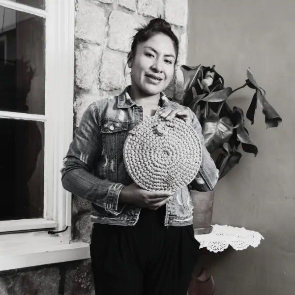 artisan holding a crochet bag, one of her creations